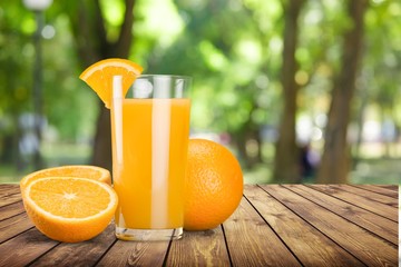 Orange juice in glass and slices of orange fruit