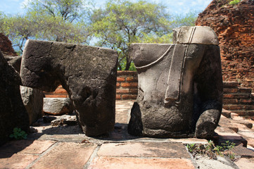 Earth Touching Buddha Torso and legs separate within Ruins