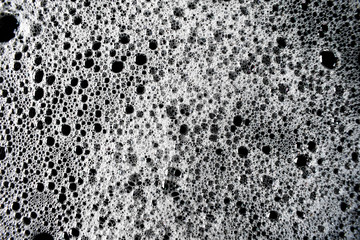 White foam bubbles on a black background