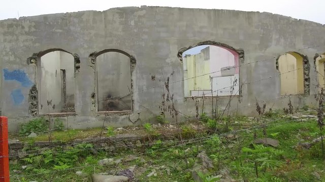 Dolly Tracking Pov side view of ruins of an abandoned house in a beautiful nature
