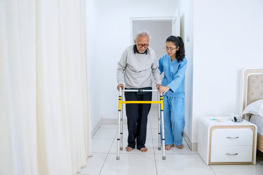 Old man doing physical treatment with nurse