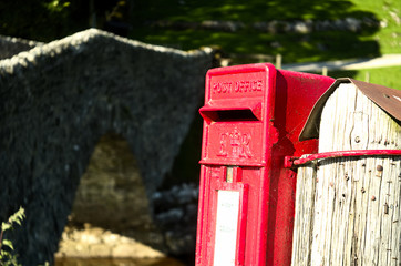 Bright red postbox in the countryside