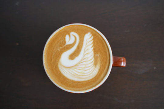 Latte art Coffee on table at cafe