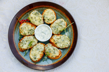 garlic bread with raw greens and sauce on a decorated table