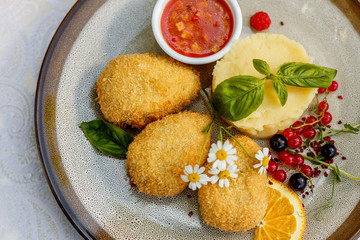 chicken nuggets with mashed potatoes and sauce on a decorated table