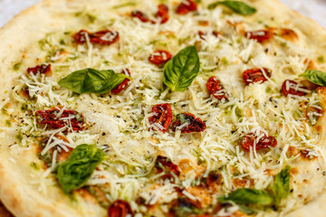 Italian focaccia bread with rosemary, basil and cheese on decorated table