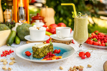 Delicate pistachio sponge cake soaked with coffee aroma on a decorated table
