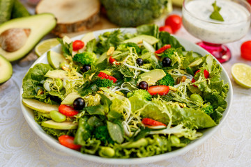 Detox, healthy vegetable salad with broccoli and avocado, healthy food on a decorated table