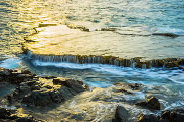 Aerial view of Fantastic big rocks and ocean waves at sundown time. Dramatic scene. Beauty world landscape. Rai cave or Hang Rai, Phan Rang, Vietnam