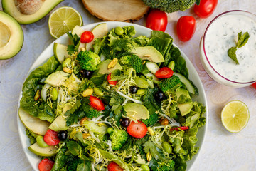 Detox, healthy vegetable salad with broccoli and avocado, healthy food on a decorated table