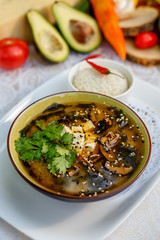 Thai soup tom yam with seafood and cheese on decorated table