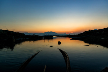 Traditional Boat and location fisherman on the beach at sunrise time, Hon Thien village, Phan Rang, Vietnam