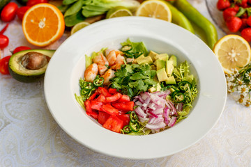 Salad with shrimps and vegetables, healthy food on the decorated table