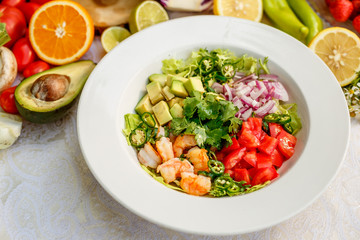 Salad with shrimps and vegetables, healthy food on the decorated table