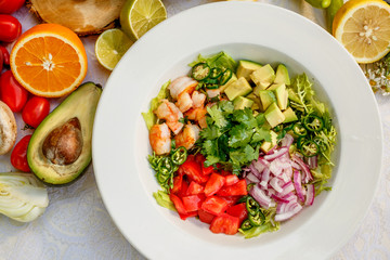 Salad with shrimps and vegetables, healthy food on the decorated table