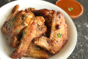 Delicious chicken wings, baked or fried chicken wings served with hot spicy  barbeque sauce