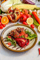 chicken thighs with rucola, nuts and vegetables on a decorated table