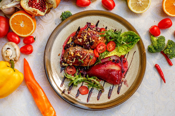 chicken thighs with rucola, nuts and vegetables on a decorated table