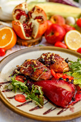 chicken thighs with rucola, nuts and vegetables on a decorated table