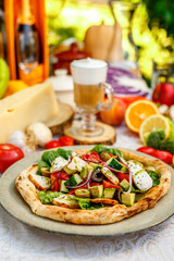 salad with chicken cheese and vegetables on a flat cake on a decorated table