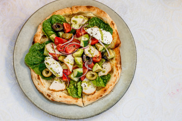 salad with chicken cheese and vegetables on a flat cake on a decorated table