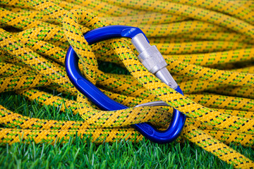 Blue screw lock carabiner with yellow dynamic climbing rope 