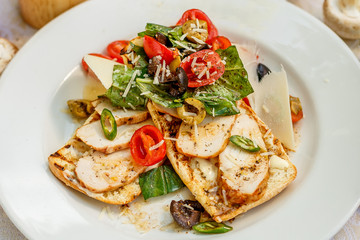 panini with chicken and vegetables on a plate on a decorated table