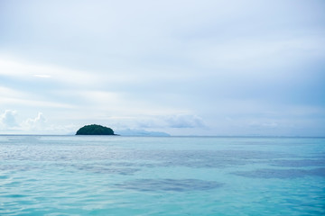 Tropical nature clean beach and white sand in summer with sun light blue sky and bokeh background.