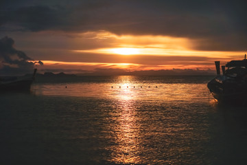 Fototapeta na wymiar Nature beach scenery in summer time with many boats sunset twilight sky.