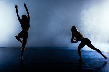 Fototapeta na wymiar Modern silhouette ballet dancers practicing