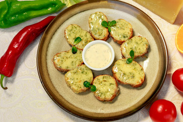 garlic bread with cheese and herbs on a white decorated table