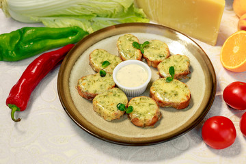 garlic bread with cheese and herbs on a white decorated table