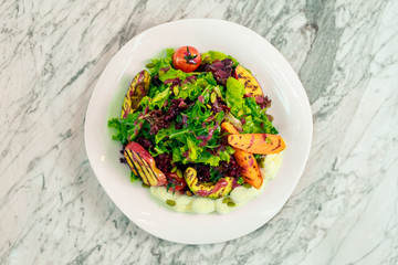salad with avocado, chicken breast and vegetables