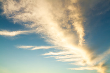 Naklejka na ściany i meble The sunlight is shining on the cloud with a blue sky background.
