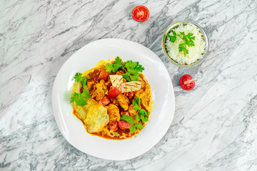 stew with vegetables, homemade chips and rice