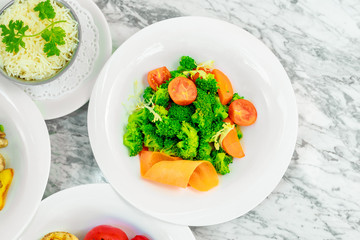 side dishes for the main course,fresh vegetables tomatoes and broccoli, beautiful serving