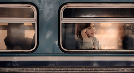  young asian woman looking through the train window. © NAMPIX