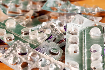 Coronavirus Covid -19. A bunch of opened used packs from various tablets are desired mixed up with each other.