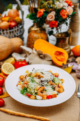 Autumn table setting with pumpkins. Thanksgiving dinner. shrimp caesar salad