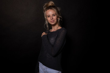 Fototapeta premium Beautiful young woman posing for photoshoot. Smiles playfully. Portrait shoot