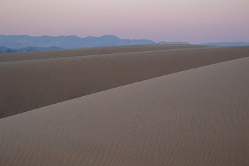 View of sand dunes during sunrise