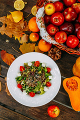 Autumn table setting with pumpkins. Thanksgiving dinner. vegetarian salad with tomatoes and cheese. Healthy food