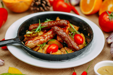 Autumn table setting with pumpkins. Thanksgiving dinner. sausages with fried potatoes in a pan