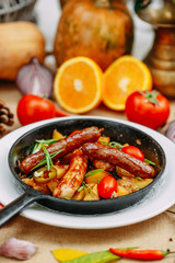 Autumn table setting with pumpkins. Thanksgiving dinner. sausages with fried potatoes in a pan