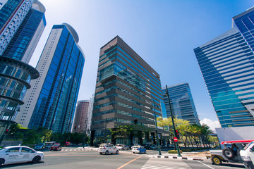 Modern buildings loom over a bustling intersection in Fort Bonifacio, Metro Manila.