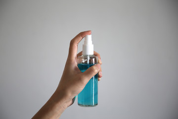 Hand of lady holding alcohol spray or anti bacteria.