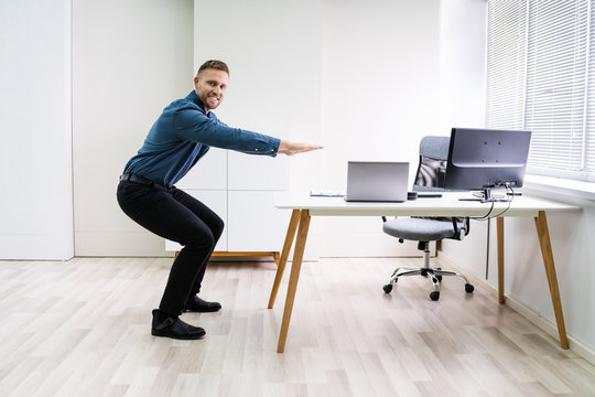 Smiling Young Businessman Doing Sit-ups