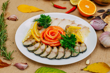 Autumn table setting with pumpkins. Thanksgiving dinner. fish platter with lemon in a white plate