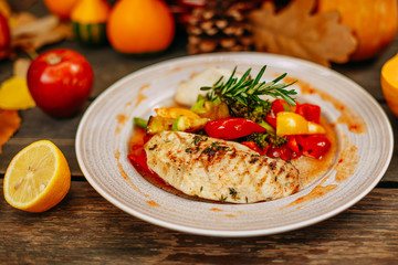 Autumn table setting with pumpkins. Thanksgiving dinner.grilled chicken breast with vegetables