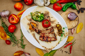 Autumn table setting with pumpkins. Thanksgiving dinner.Tomahawk Pork Steak with Vegetables